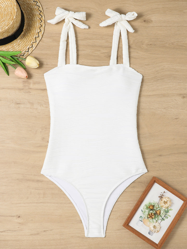 Women's figure-fitting one-piece swimsuit with playful bow details StylebySassy