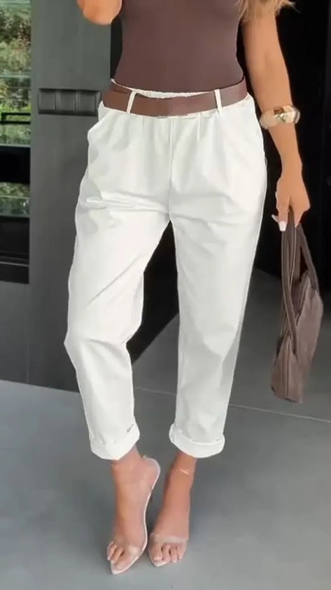Women's high-waisted paperbag pants with gathered waistband, side pockets, and rolled hem StylebySassy