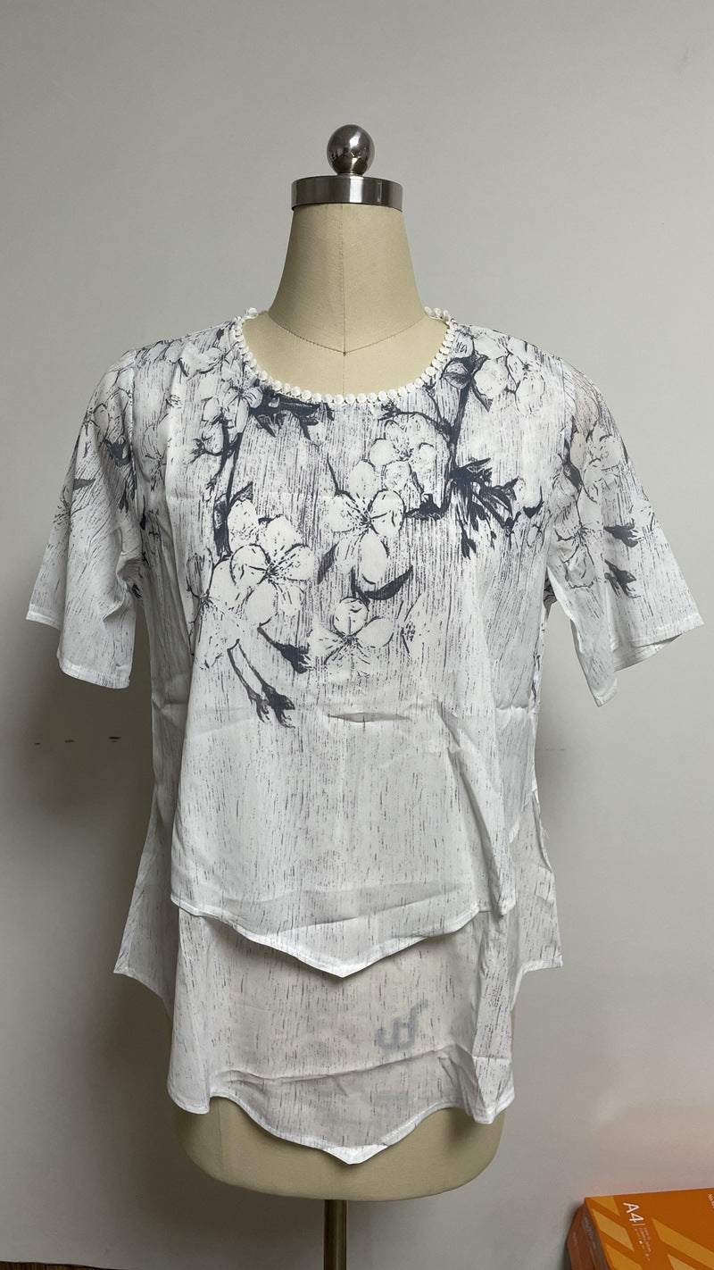 Women's two-layer blouse dress with asymmetrical tiered hem, floral print yoke, and wing sleeves StylebySassy