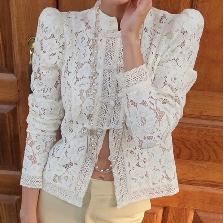 Women's figure-hugging lace blouse with stand collar, decorative knot closure, and crocheted hem StylebySassy