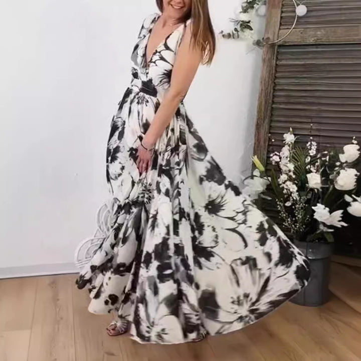 Women’s voluminous A-line maxi dress with deep V-neck, tailored tie belt and large floral brush print StylebySassy