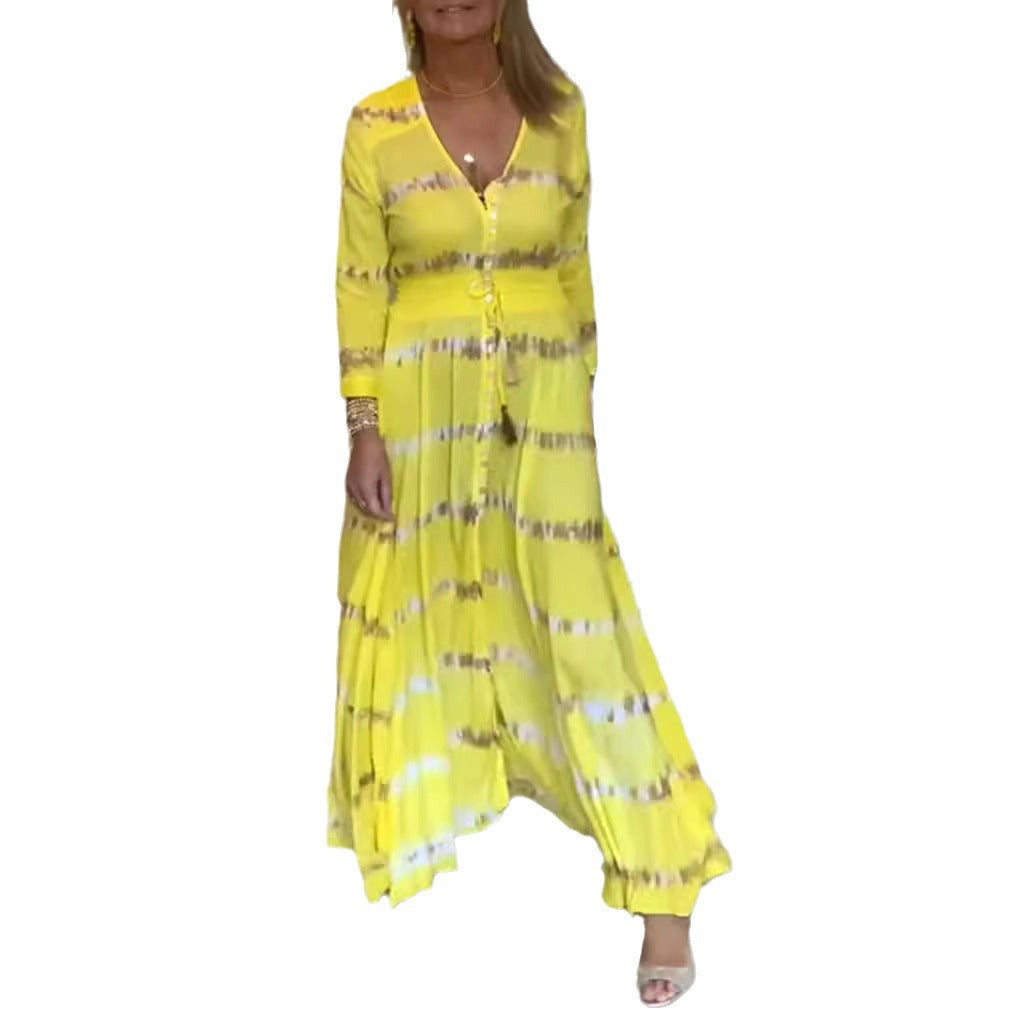 Women's flowing maxi dress with V-neck, full button placket, fitted tassel belt, and pleated skirt StylebySassy