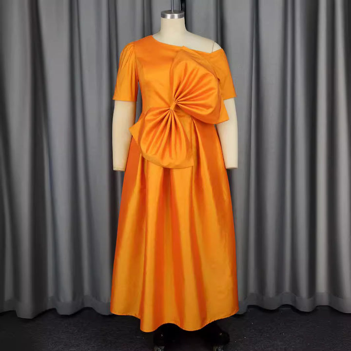 Women's festive evening dress with asymmetric neckline and voluminous draping element StylebySassy