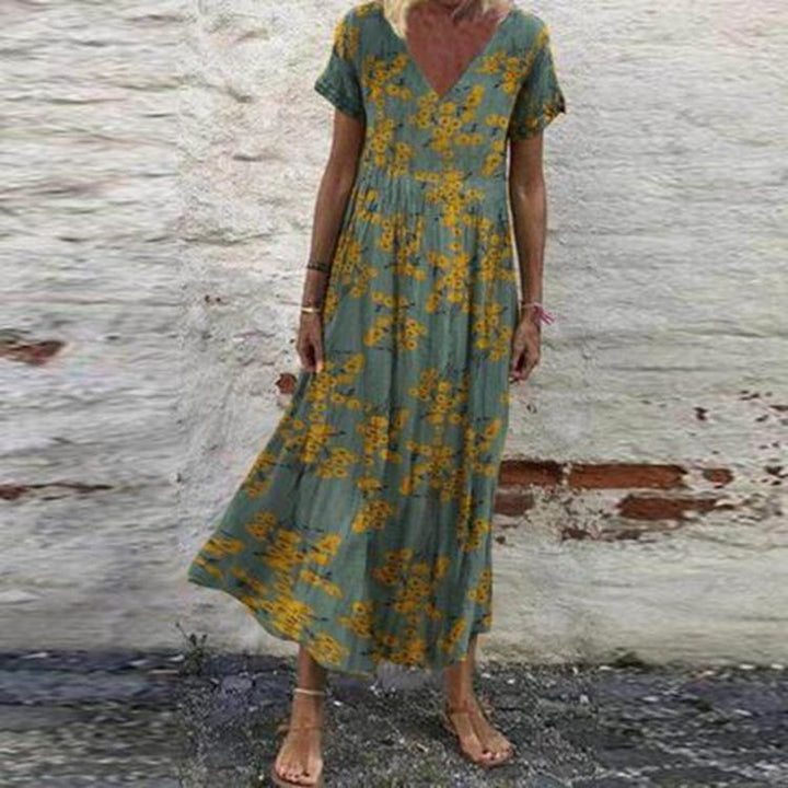 Women’s V-neck maxi dress with fine pleated skirt, empire bodice and short sleeves StylebySassy