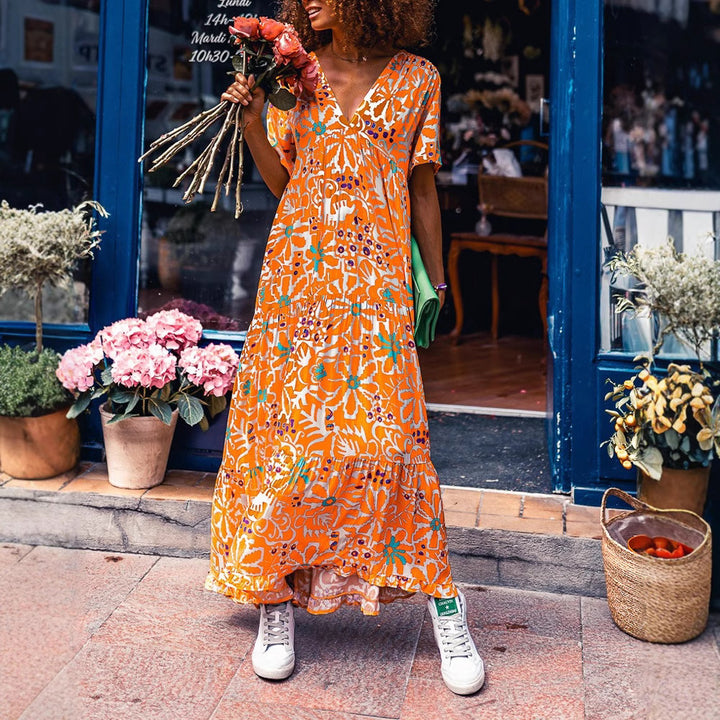 Women’s ankle-length V-neck maxi dress with graphic ethnic print, short sleeves and flared ruffle hem StylebySassy