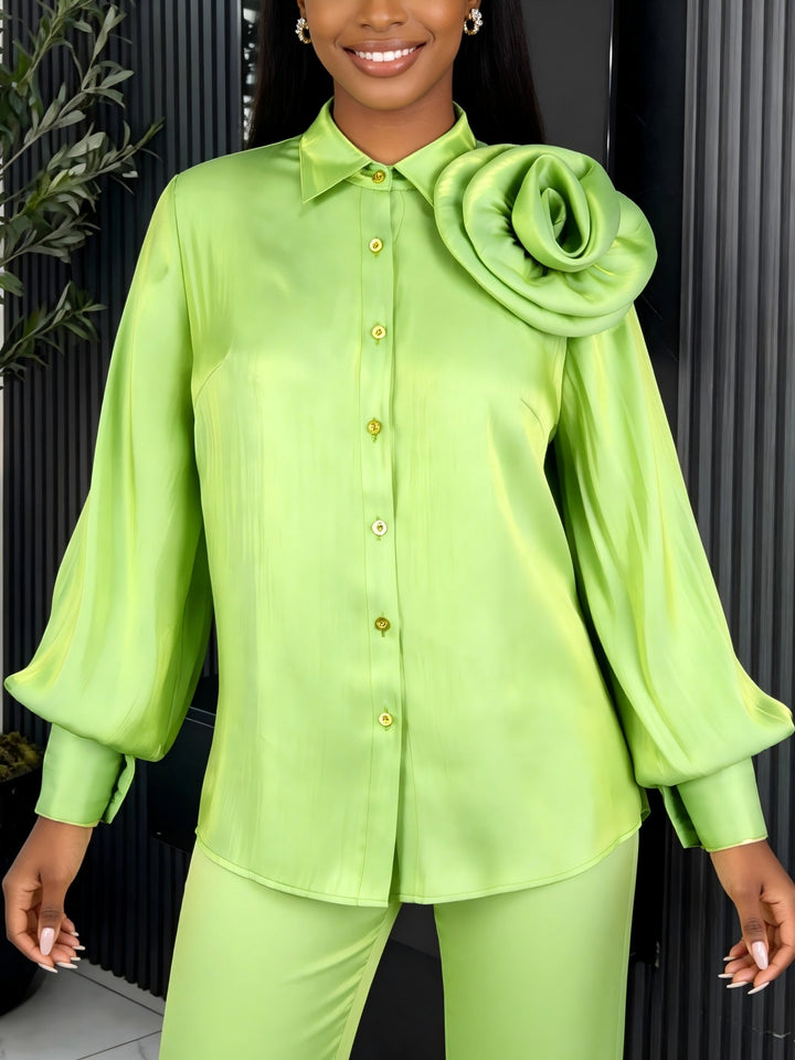 Women’s satin skirt with floral ruffle design and fitted bow detail.