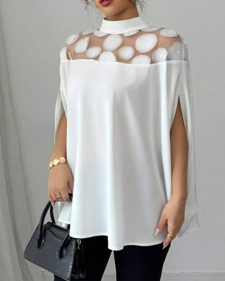 Women’s loose-fitting blouse with transparent round appliqué insert and cape sleeves StylebySassy