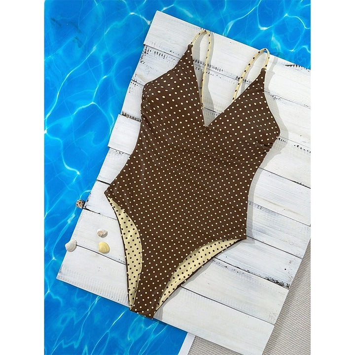 Women's one-piece swimsuit with deep V-neckline and decorative dots StylebySassy