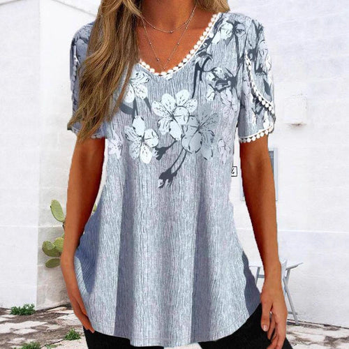 Women's flowing V-neck tunic top with floral print pompom trim and A-line cut StylebySassy