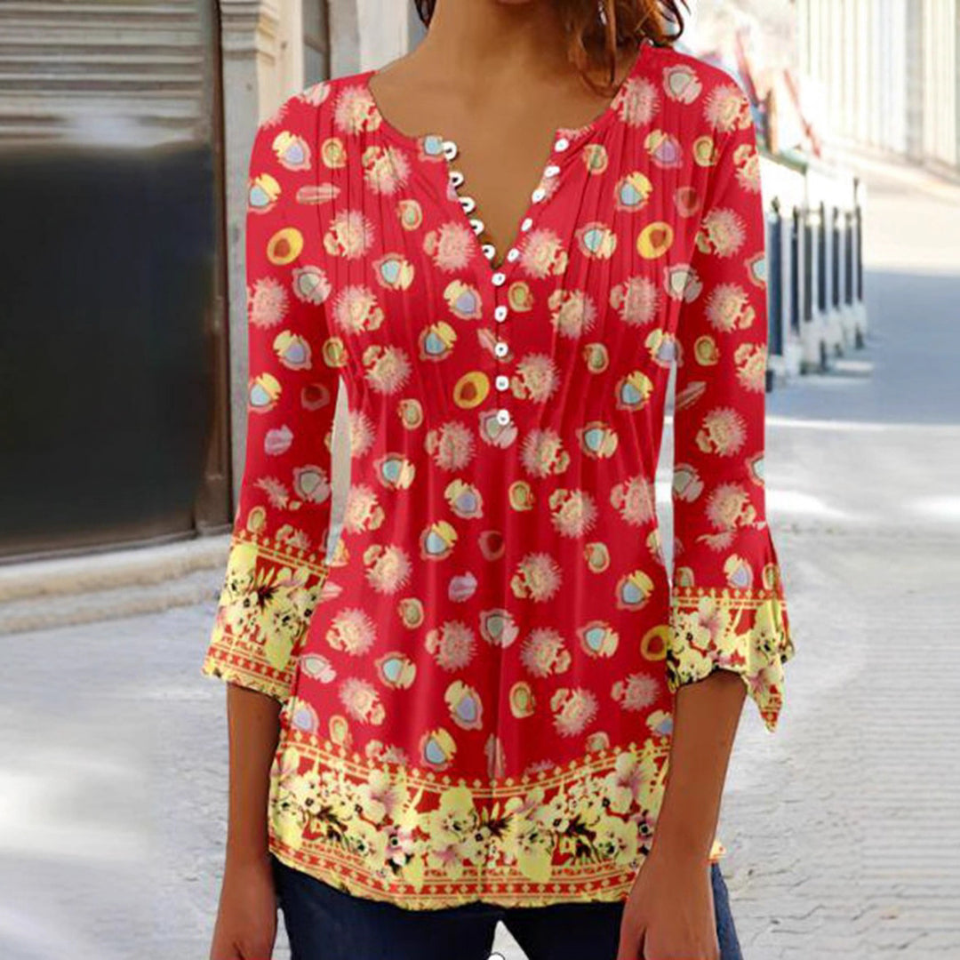 Women's flowing V-neck tunic with decorative button placket, chest pleats, three-quarter sleeves, and floral border edge StylebySassy