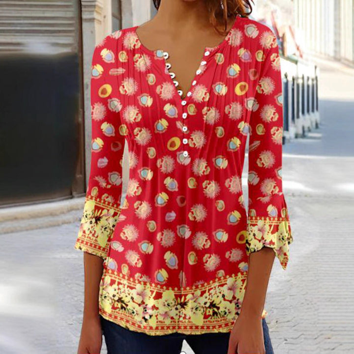 Women's flowing V-neck tunic with decorative button placket, chest pleats, three-quarter sleeves, and floral border edge StylebySassy
