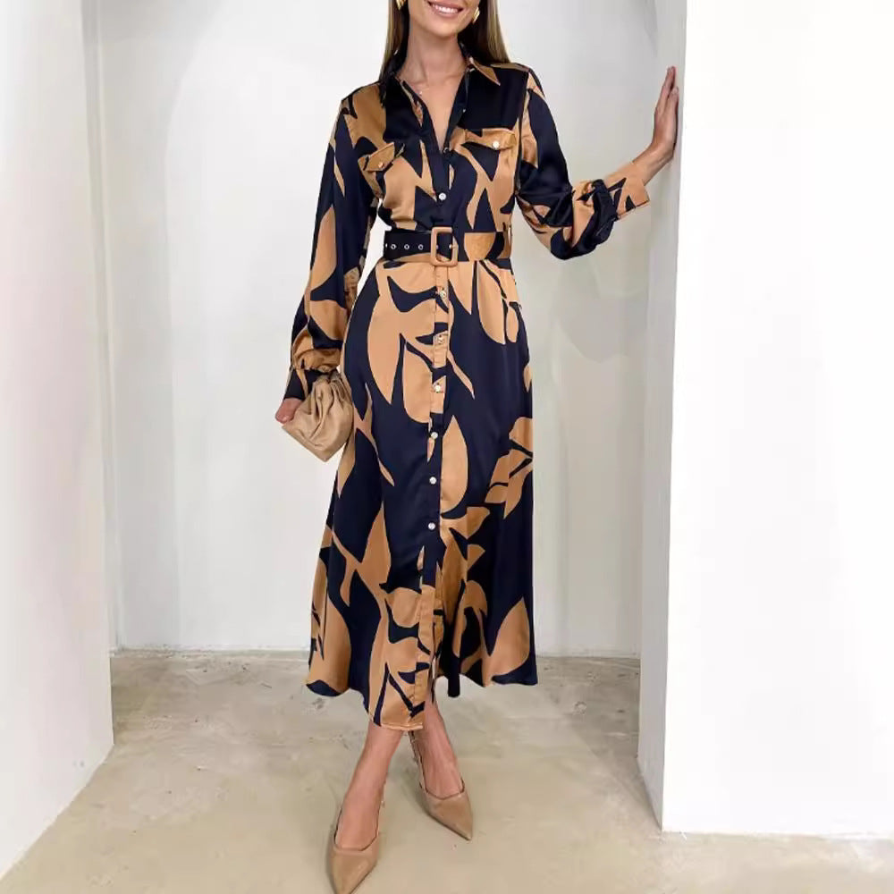 Ladies' elegant satin shirt dress with waist belt, chest pockets, and abstract leaf print StylebySassy