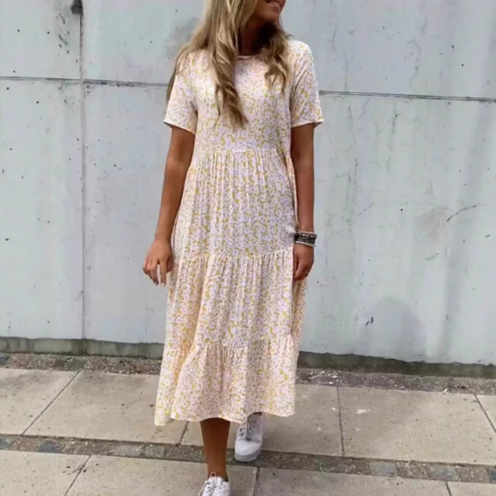 Women's flowing tiered maxi dress in Boho babydoll style with gathered underbust and short sleeves StylebySassy