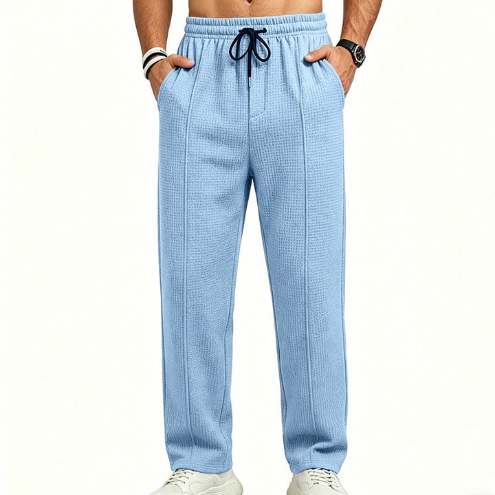 Men's straight-cut relaxed trousers with decorative center seam, elasticated drawstring waistband and side pockets StylebySassy