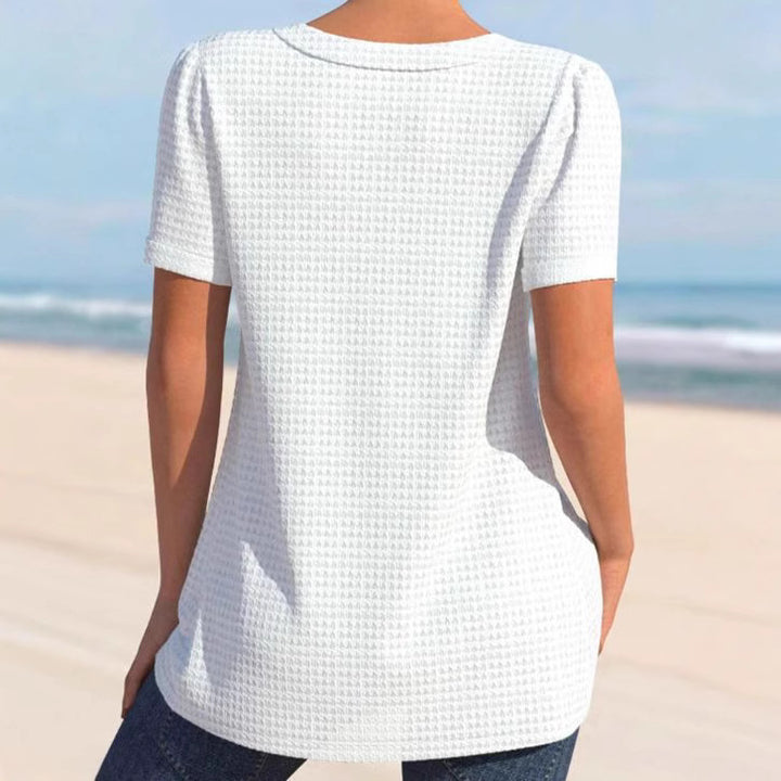 Women's finely structured V-neck top with decorative button placket and slightly flared silhouette StylebySassy