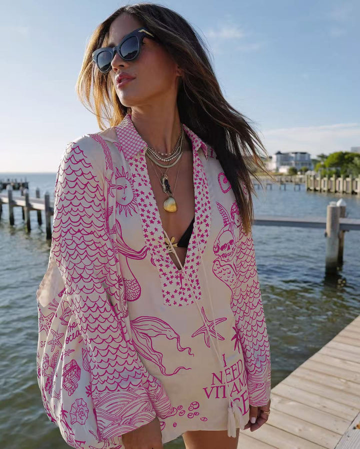 Ladies lightweight beach cover-up in tunic form with deep V-neck, tassel closure, and nautical ocean print StylebySassy