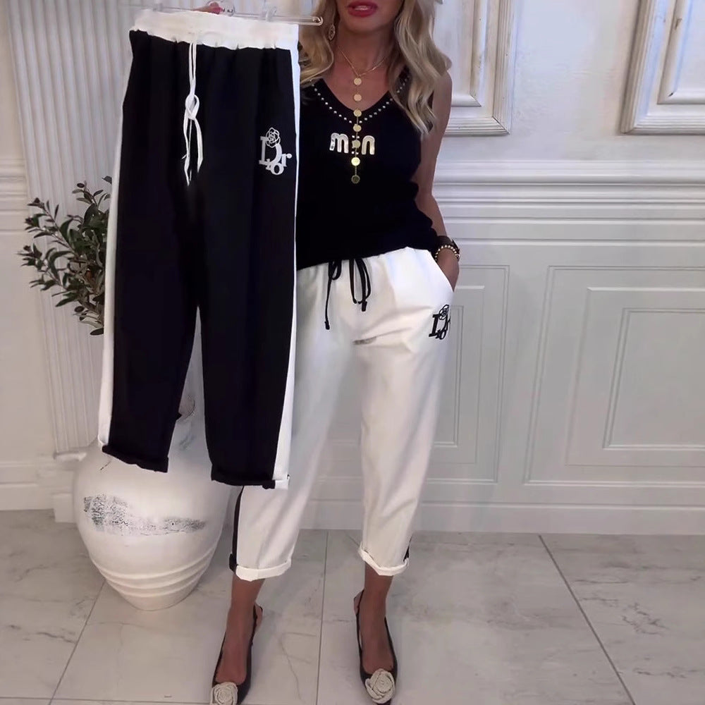 Women's Cropped Jogging Pants with contrasting waistband, side decorative stripe, drawstring, and logo embroidery StylebySassy