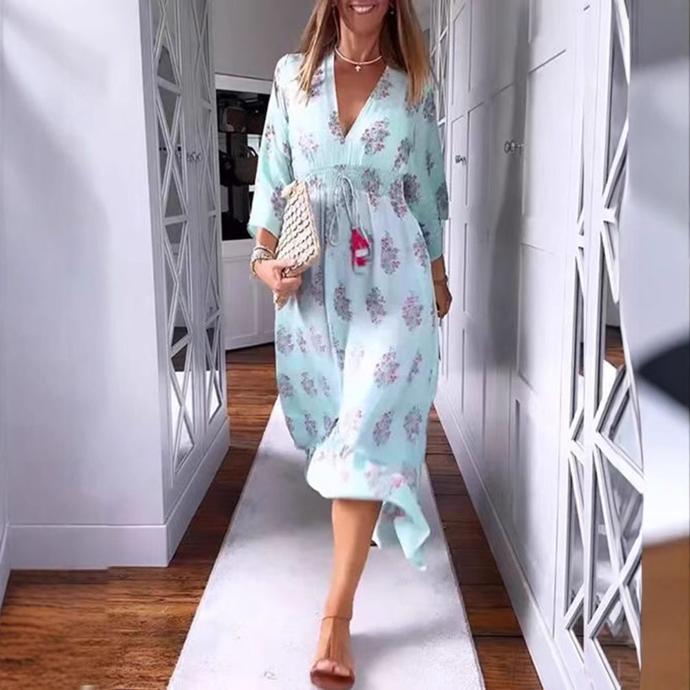 Women’s airy-flowing Boho midi dress with V-neck, gathered smock waist, drawstring with tassels, and asymmetrical ruffled hem StylebySassy