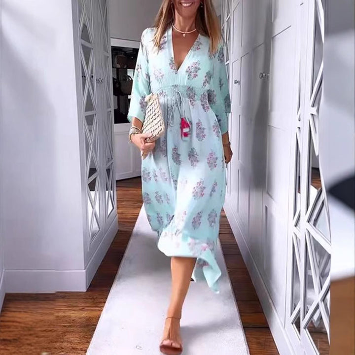Women’s airy-flowing Boho midi dress with V-neck, gathered smock waist, drawstring with tassels, and asymmetrical ruffled hem StylebySassy