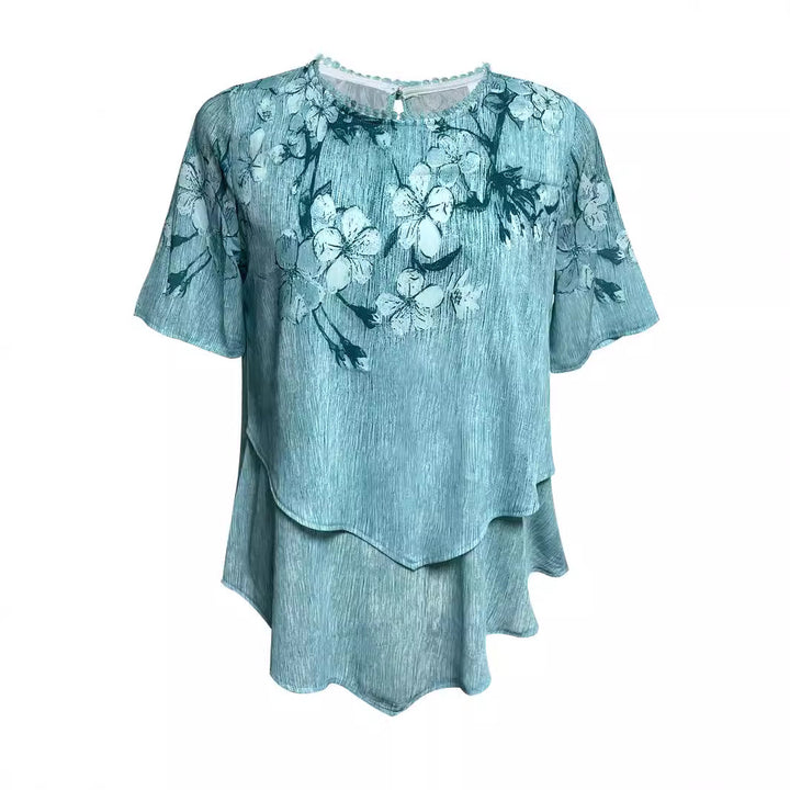 Women's two-layer blouse dress with asymmetrical tiered hem, floral print yoke, and wing sleeves StylebySassy