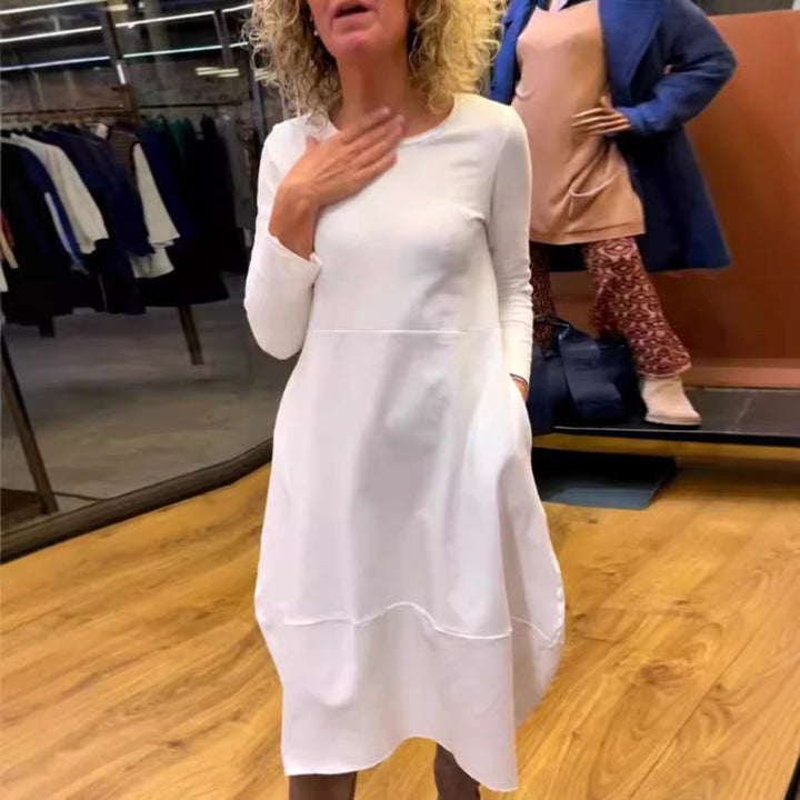 Women's asymmetrical balloon dress with three-quarter sleeves, side pockets, and flowing pointed hem StylebySassy