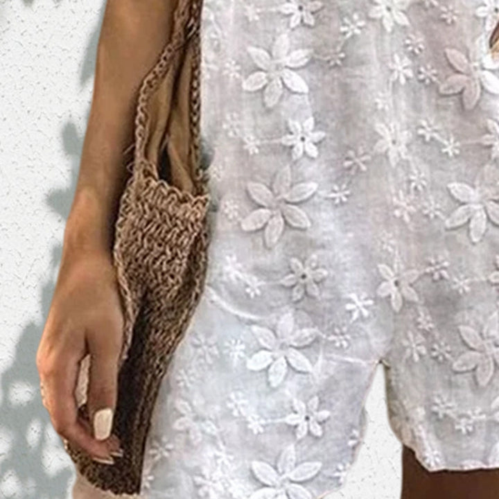 Women's lighter short overall with floral three-dimensional embroidery, adjustable tie straps and loose A-line silhouette StylebySassy