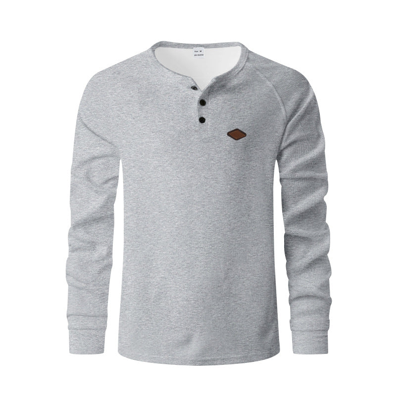 Men's structured long-sleeve shirt with short button placket, raglan sleeves, and subtle logo application StylebySassy