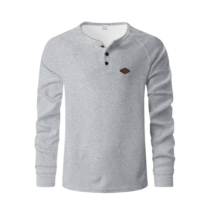Men's structured long-sleeve shirt with short button placket, raglan sleeves, and subtle logo application StylebySassy