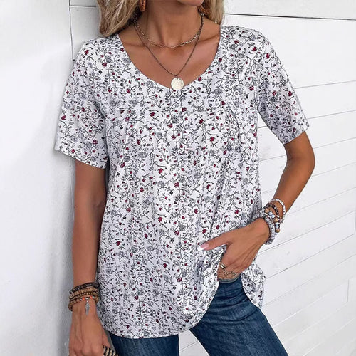 Ladies casual short-sleeve tunic shirt with round neckline, delicate all-over floral print and decorative chest pleats StylebySassy