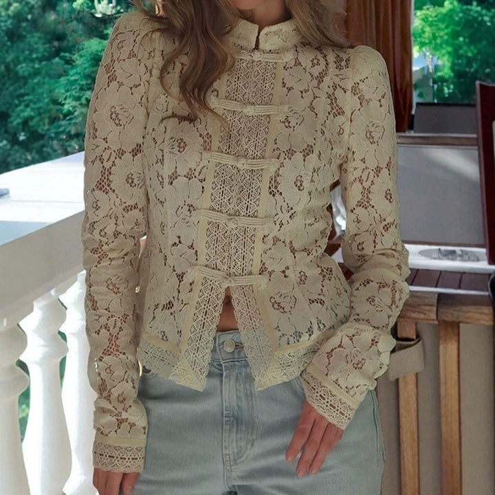 Women's figure-hugging lace blouse with stand collar, decorative knot closure, and crocheted hem StylebySassy