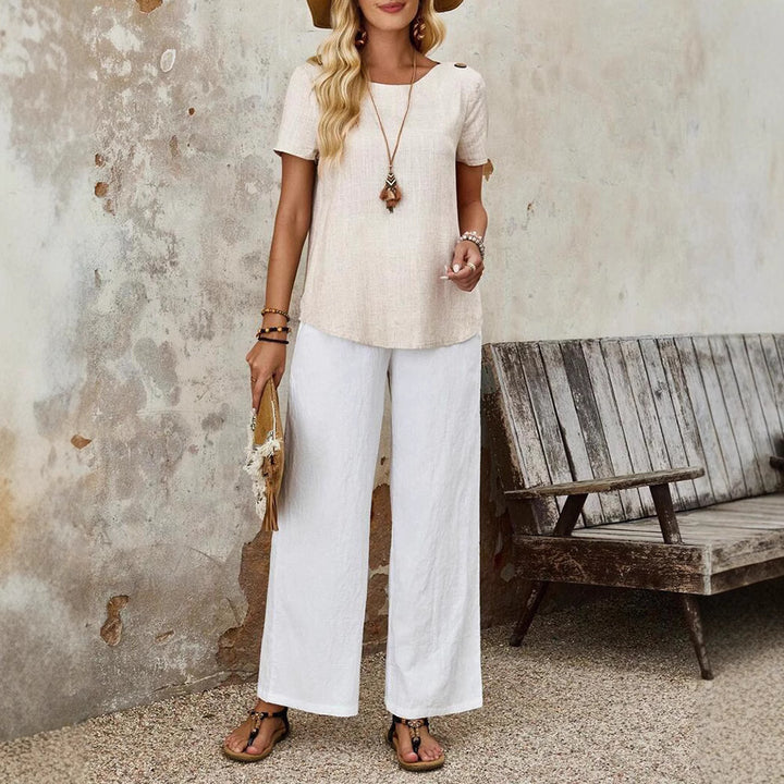 Women's relaxed fit linen blend tunic top with round neckline, wooden button details on the shoulder and curved hem StylebySassy