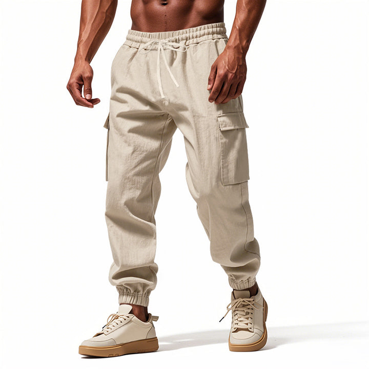 Men's tapered joggers in utilitarian style with elastic waistband, drawstring, and flap pockets StylebySassy