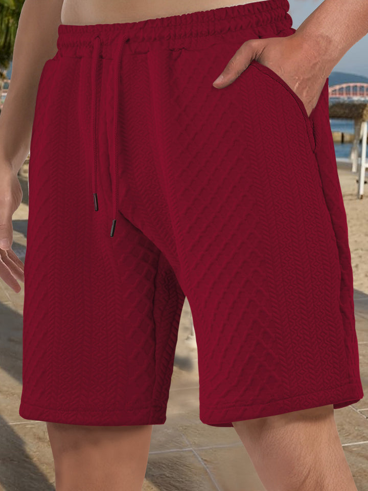 Men's textured beach bermuda shorts made of waffle jersey with elastic drawstring waistband and slanted pockets StylebySassy