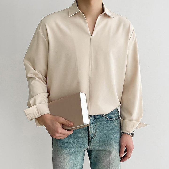 Women's loosely cut tunic blouse with deep V-neck, concealed button placket, and dropped shoulders StylebySassy