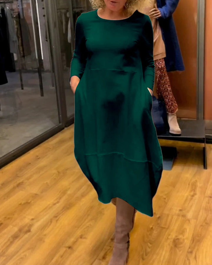 Women's asymmetrical balloon dress with three-quarter sleeves, side pockets, and flowing pointed hem StylebySassy