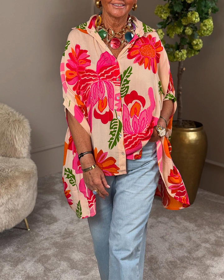 Women's airy oversized resort-style shirt blouse with large floral print and asymmetrical scalloped hem StylebySassy