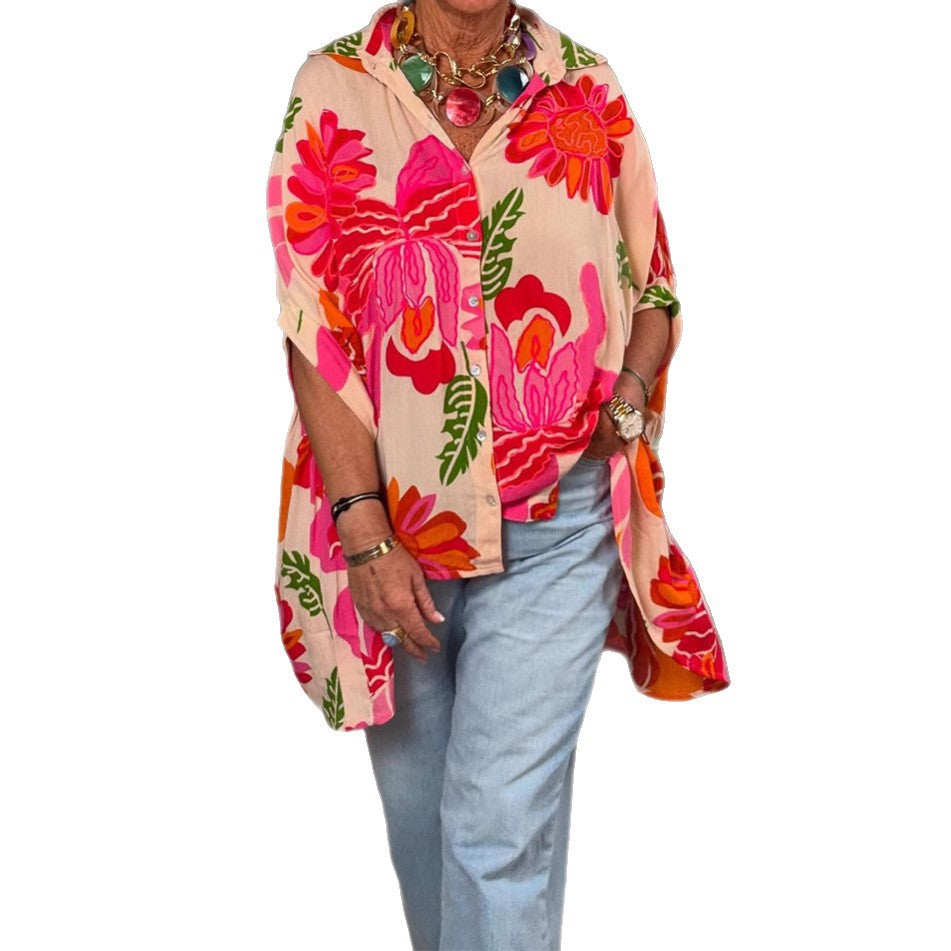 Women's airy oversized resort-style shirt blouse with large floral print and asymmetrical scalloped hem StylebySassy