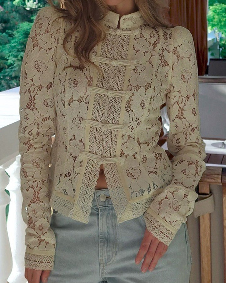 Women's figure-hugging lace blouse with stand collar, decorative knot closure, and crocheted hem StylebySassy