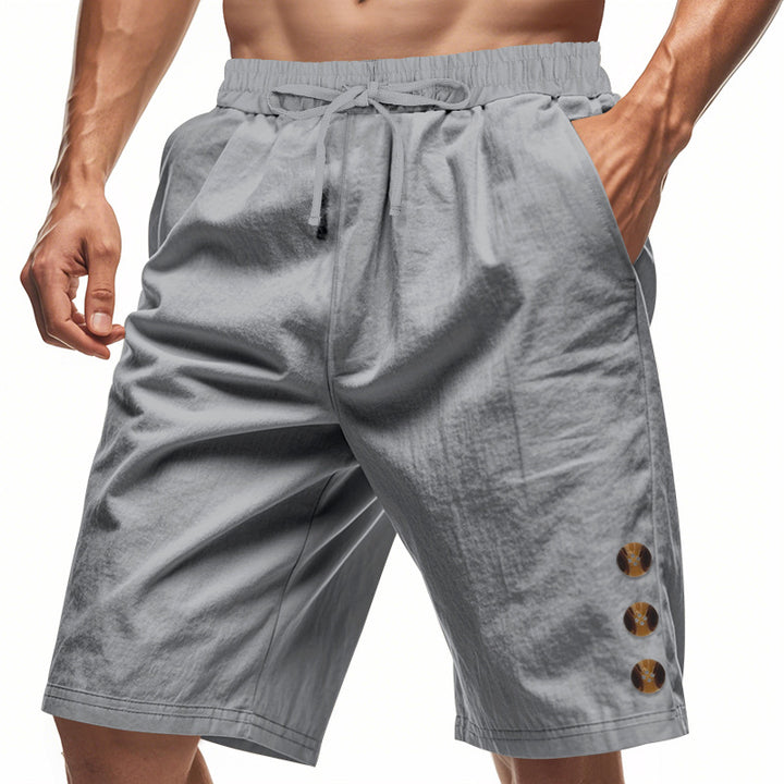 Men's knee-length casual Bermuda shorts with elastic tunnel drawstring waist, side slit pockets, and round decorative appliqués StylebySassy