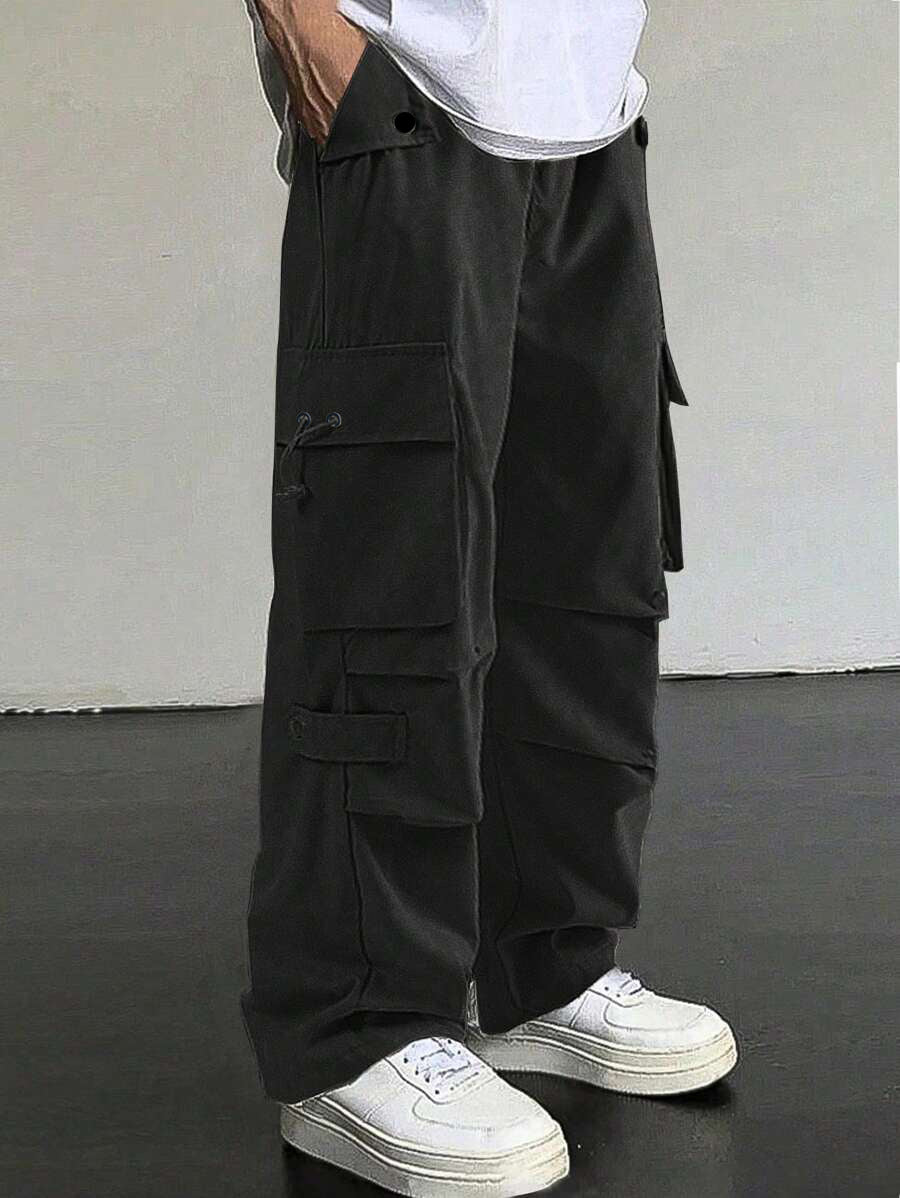 Men's baggy cargo pants with utilitarian flap pockets, drawstring waistband, and reinforced seams StylebySassy