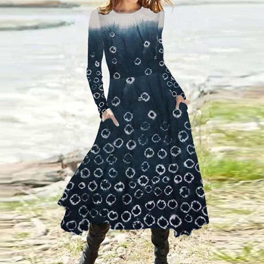 Women's flowing maxi dress with tie-dye circle pattern, round neckline, waist seam, and side pockets StylebySassy