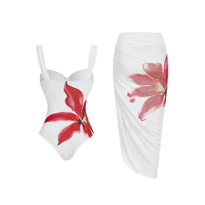 Women's one-piece swimsuit with elegant flower appliqué and draped skirt StylebySassy
