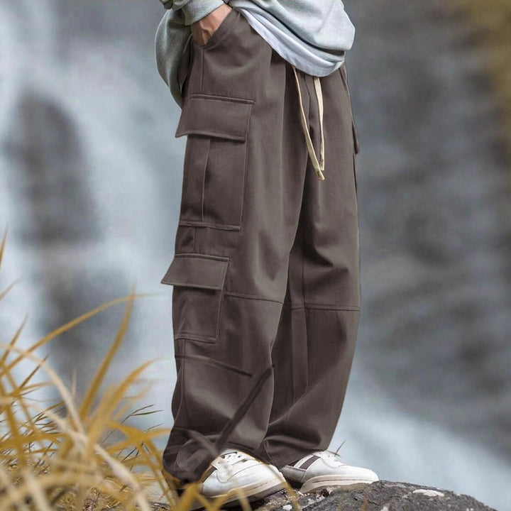 Men's casually cut multiple pockets cargo pants with wide leg and prominent knee darts StylebySassy