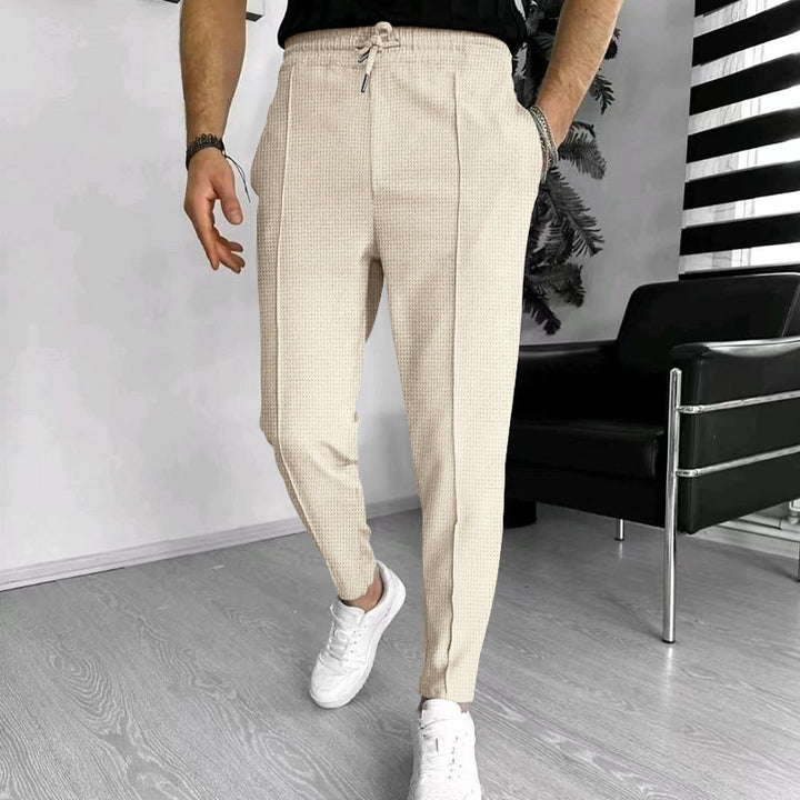 Men's tapered jogging chinos made of structured woven quality with elastic drawstring waistband and decorative crease StylebySassy