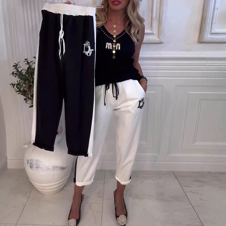 Women's Cropped Jogging Pants with contrasting waistband, side decorative stripe, drawstring, and logo embroidery StylebySassy
