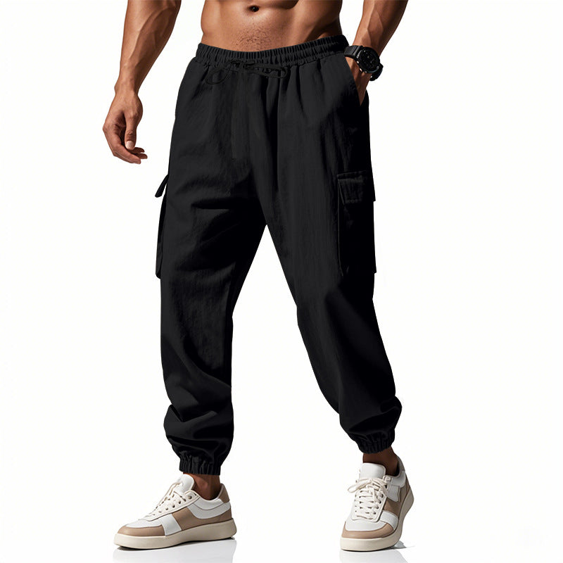 Men's tapered joggers in utilitarian style with elastic waistband, drawstring, and flap pockets StylebySassy