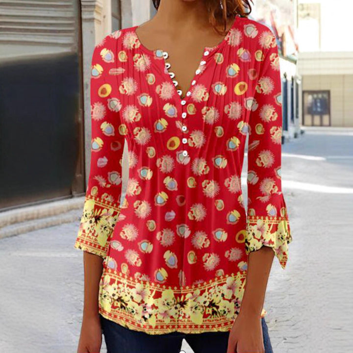 Women's flowing V-neck tunic with decorative button placket, chest pleats, three-quarter sleeves, and floral border edge StylebySassy
