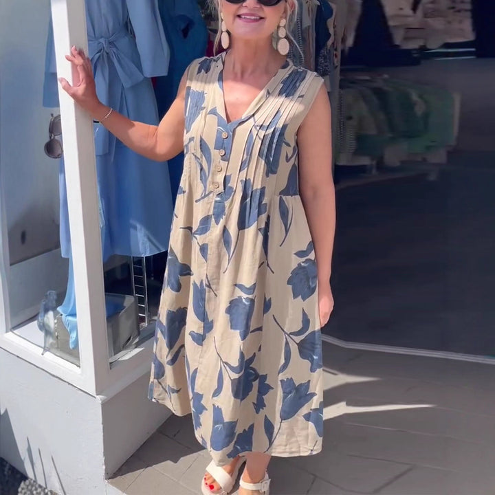 Women’s casual V-neck midi dress with bust yoke, vertical pleats, and decorative button placket StylebySassy