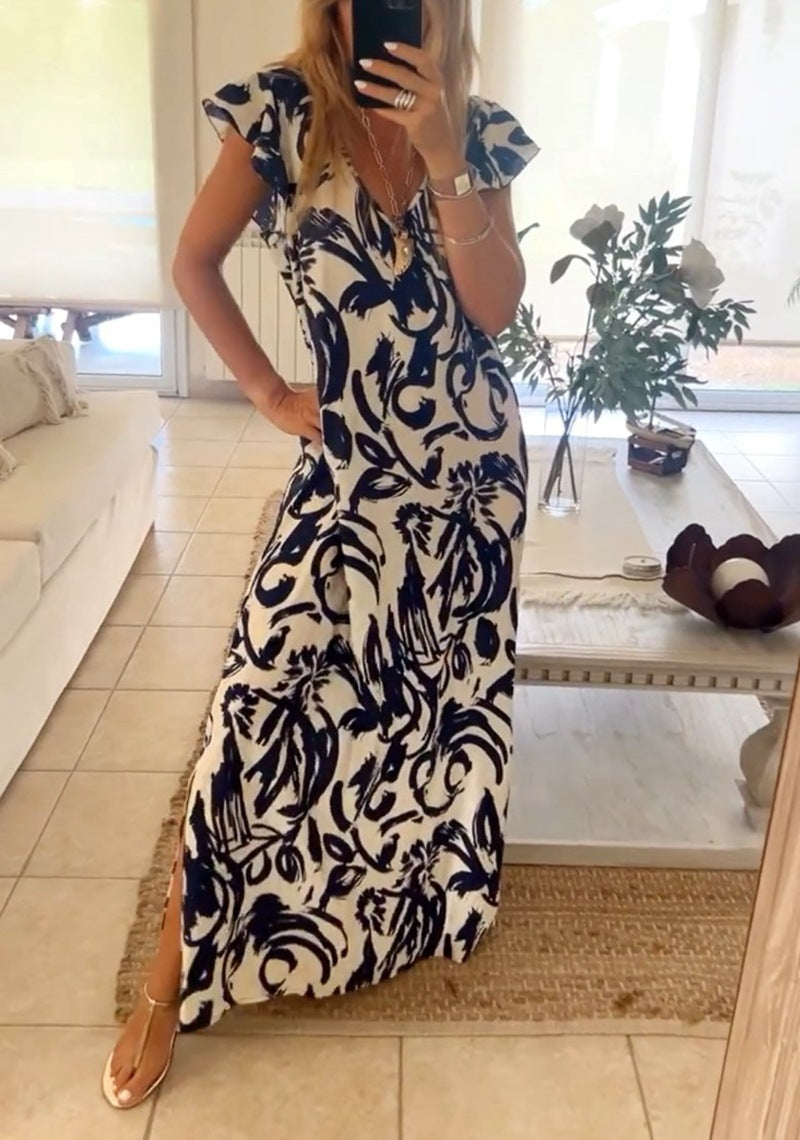 Women's flowing maxi dress with V-neck, flutter sleeves, and side leg slit StylebySassy