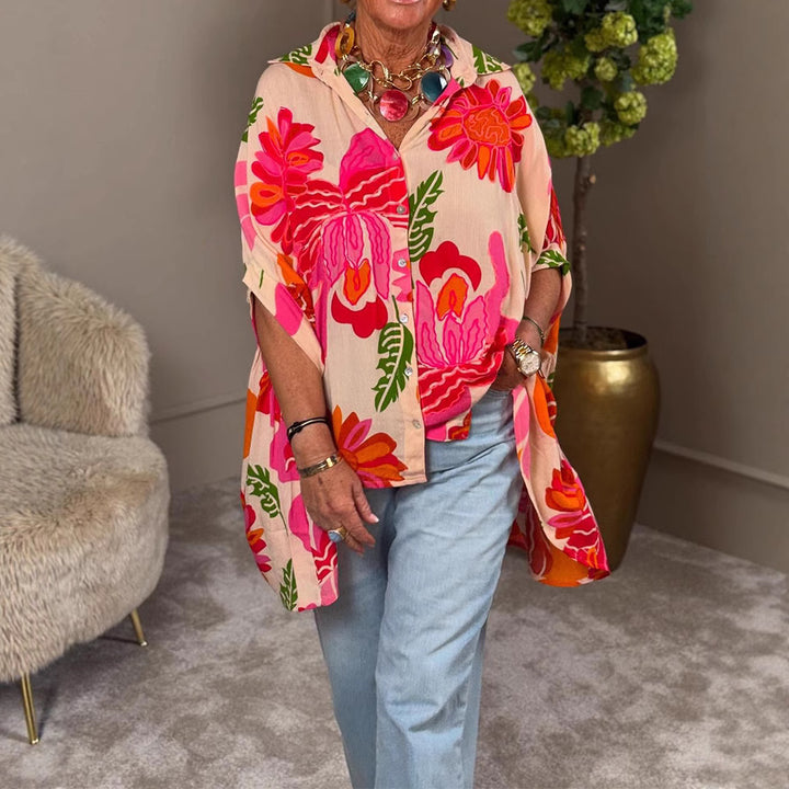 Women's airy oversized resort-style shirt blouse with large floral print and asymmetrical scalloped hem StylebySassy